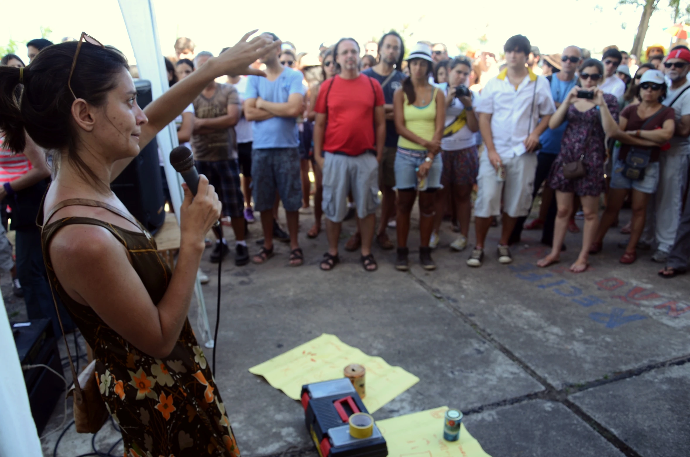 a woman is standing in front of a group and holding a microphone