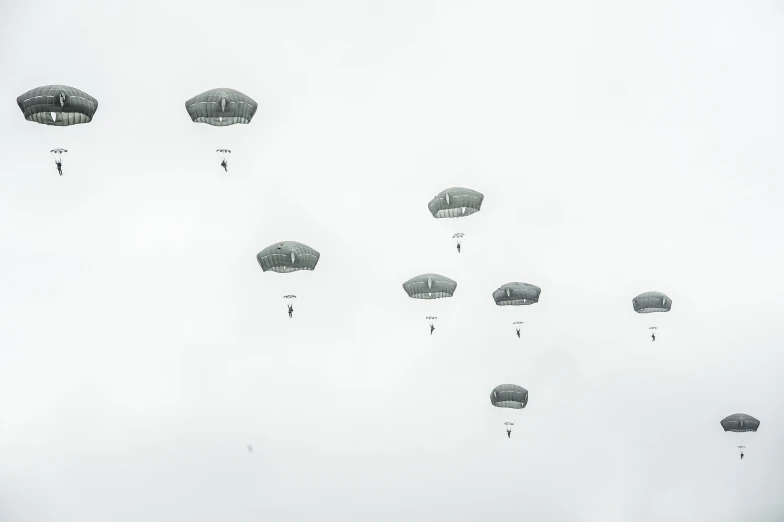 multiple parachutes that are flying in the air