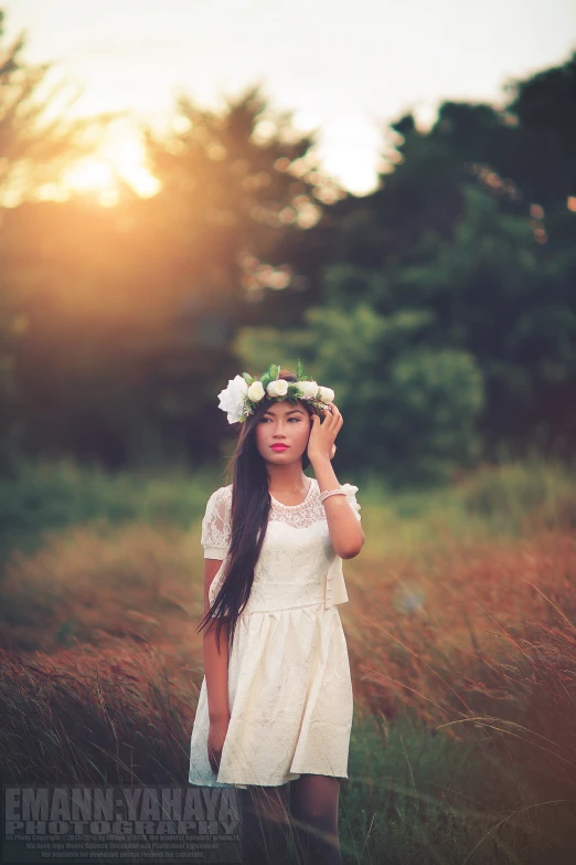 a woman is holding flowers in her hair