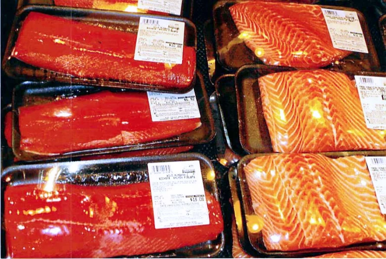 several trays of salmons in a case