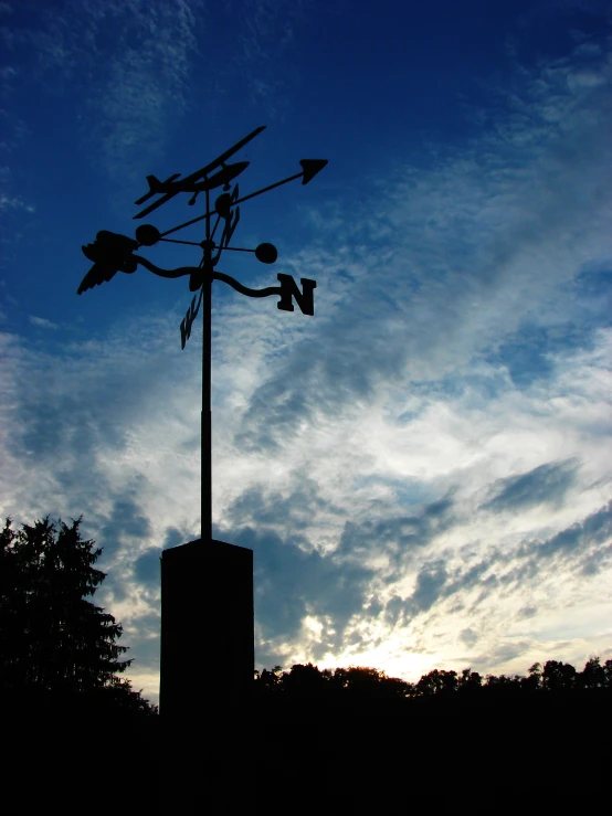 a small wind turbine on top of a square tower