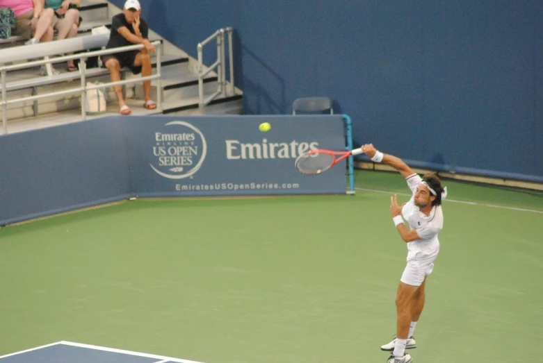 tennis player in action with the ball in his hand