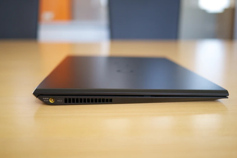 a closed laptop sitting on a table with an additional keyboard