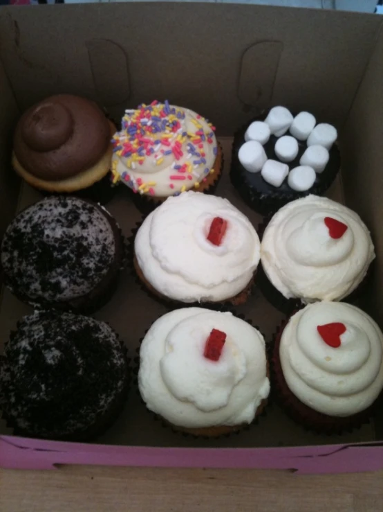 a box with six different types of doughnuts
