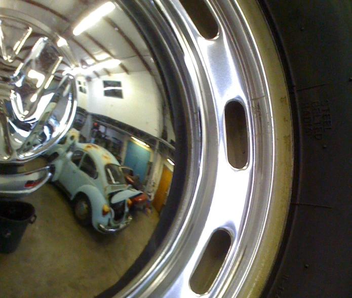 a round mirror is seen in a vehicle dealership