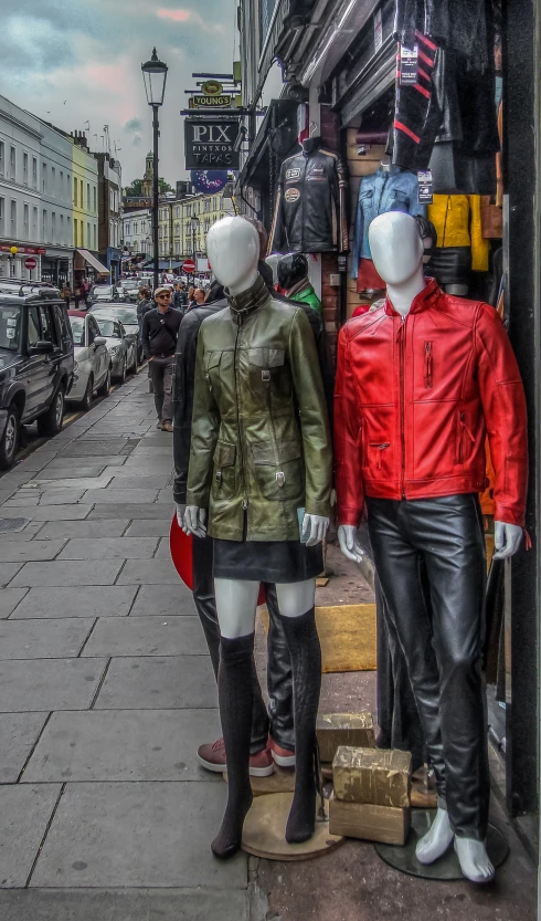 there are two mannequins wearing jackets on this street