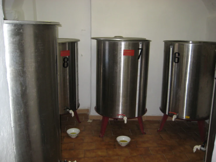 the three big silver toilets are lined up