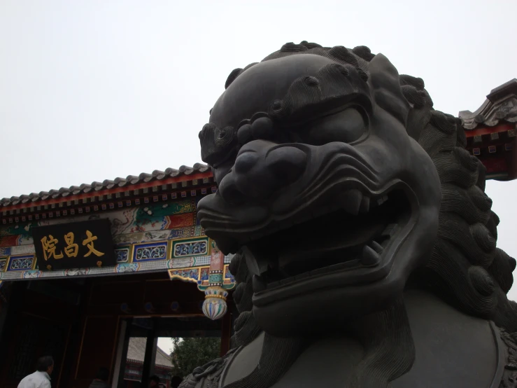 a lion statue in front of a decorated building