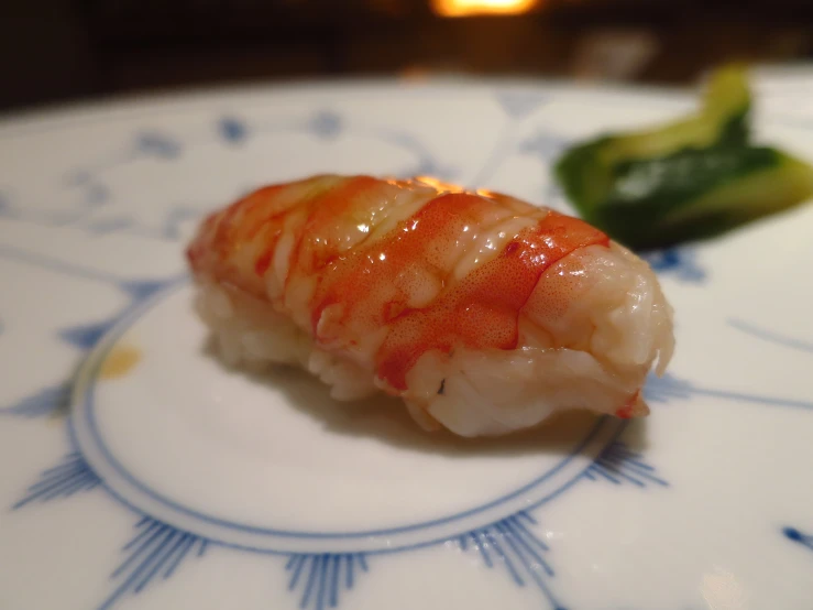 there is a sushi on a plate with chopsticks