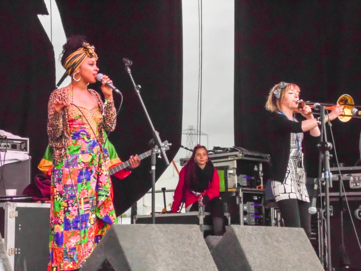 three people are playing instruments on a stage