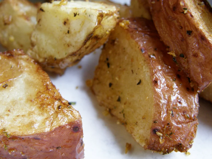 baked potatoes that have been smashed are sitting on a plate