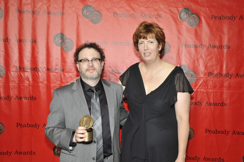 a man and woman holding an award