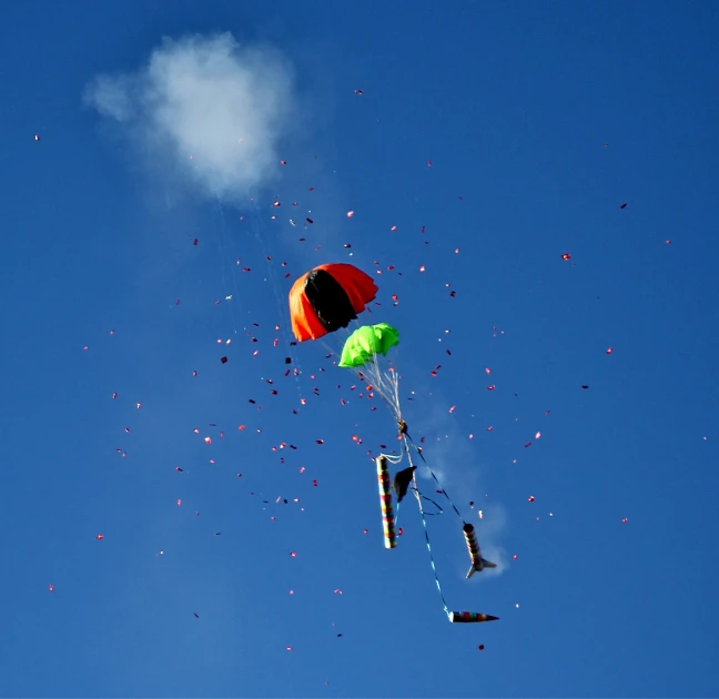 several colorful kites flying in the sky together