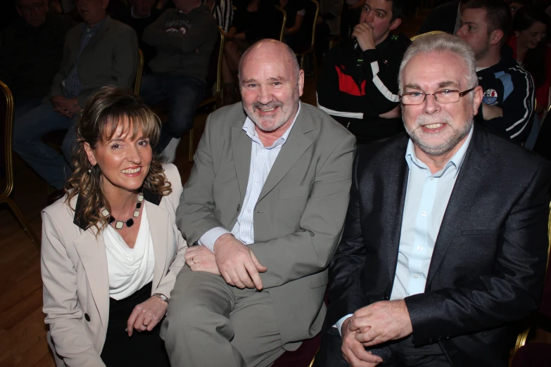 three men and one woman sitting together at a party