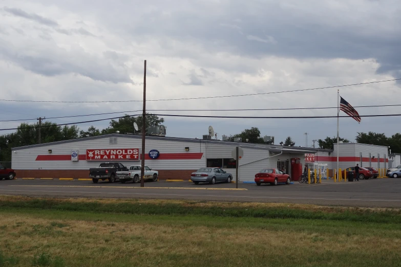 a parking lot with cars parked outside of a small store