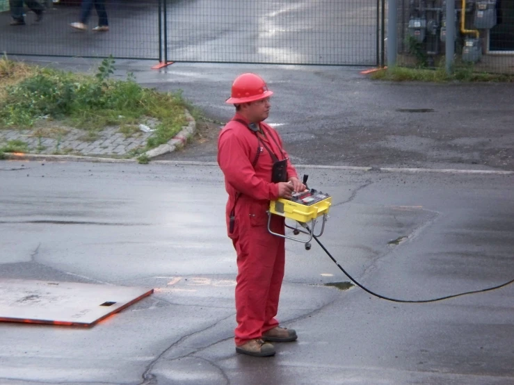 an electrician on the street spraying water