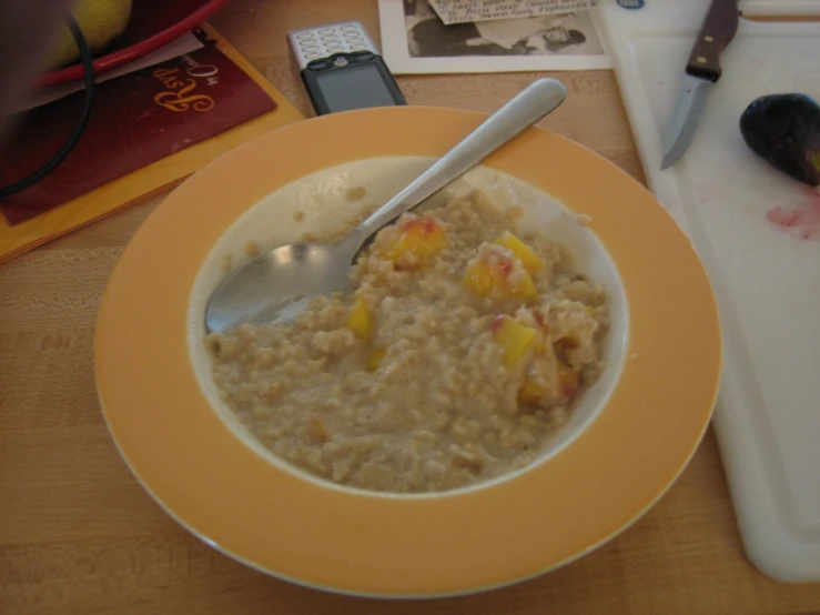 oatmeal in a bowl with silver spoon on the edge