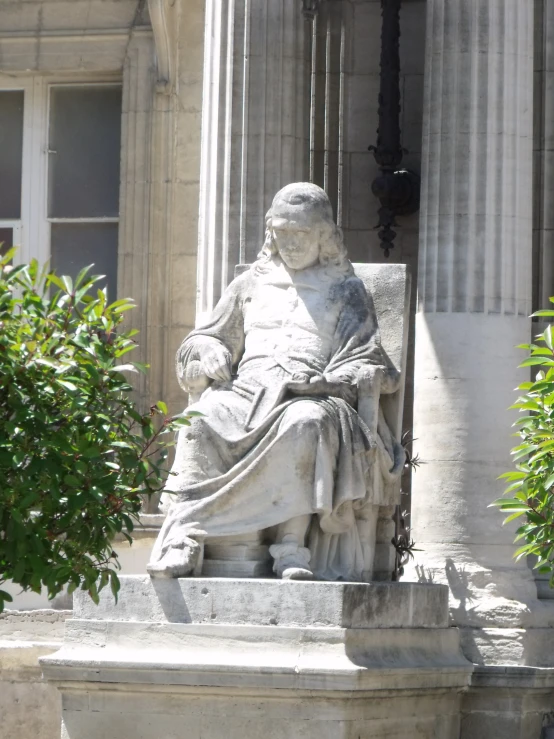 a sculpture of the greek god medusan in front of an old stone building