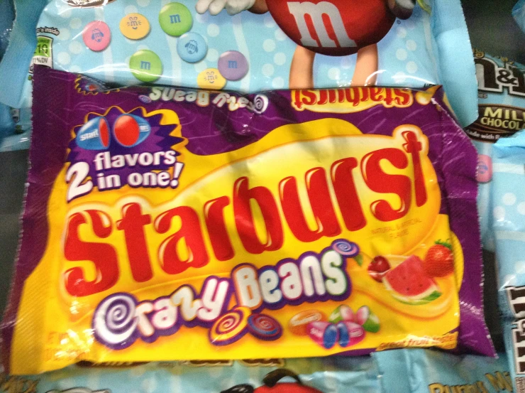 candy bag lying on top of a blanket next to other candies