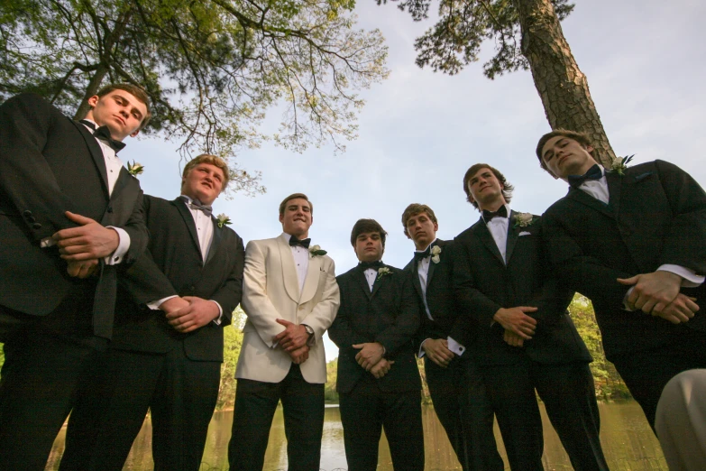 young men in suits and tie standing next to each other