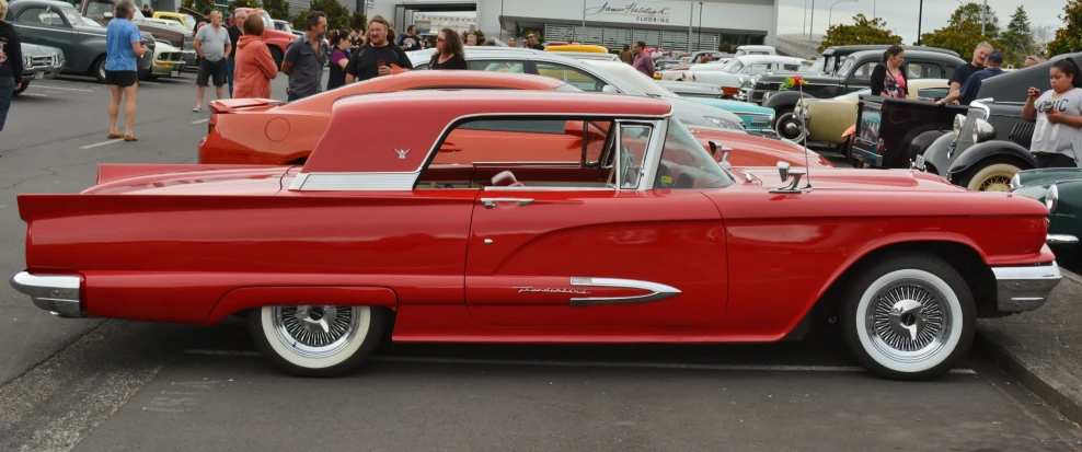 a vintage red car at an auto show