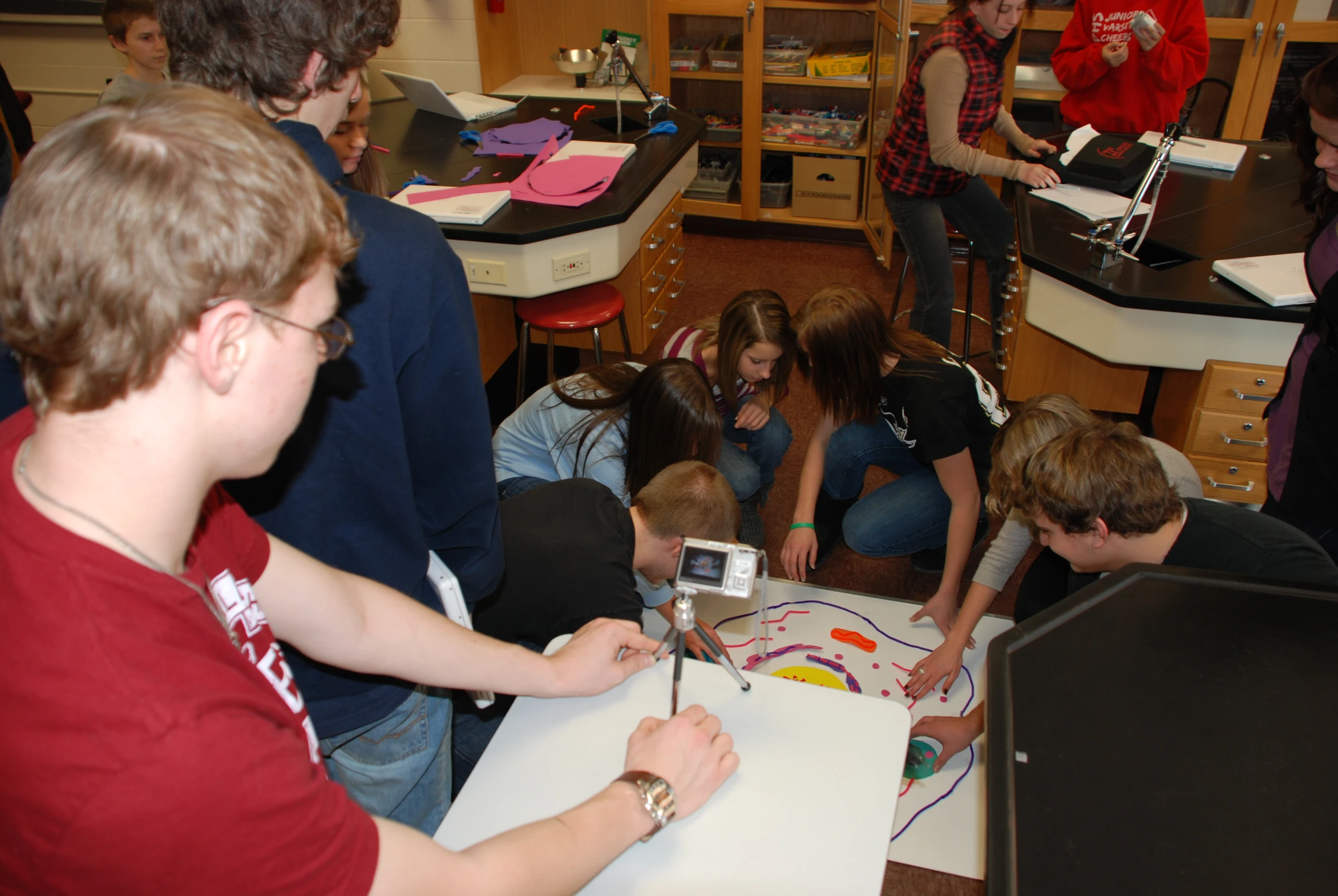 group of students working with drawings in a classroom