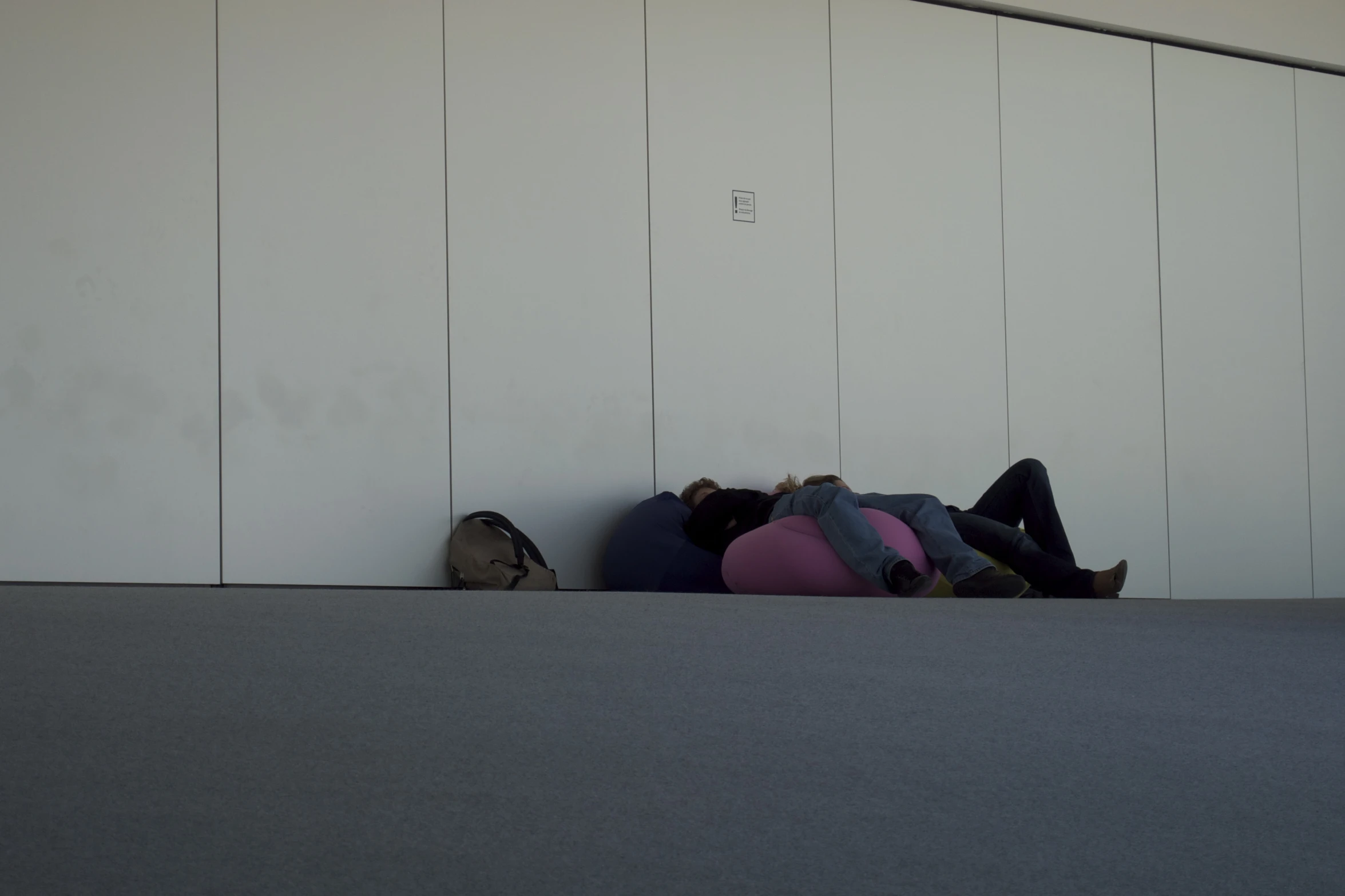 a man and woman who are laying down on the ground