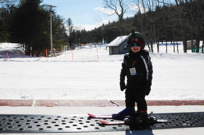 a  in winter gear standing next to a ski