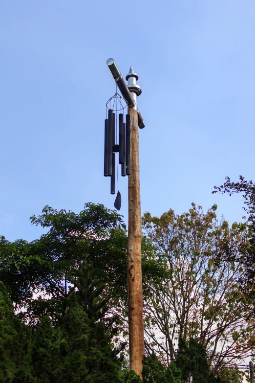 a telephone pole with several phones attached to it