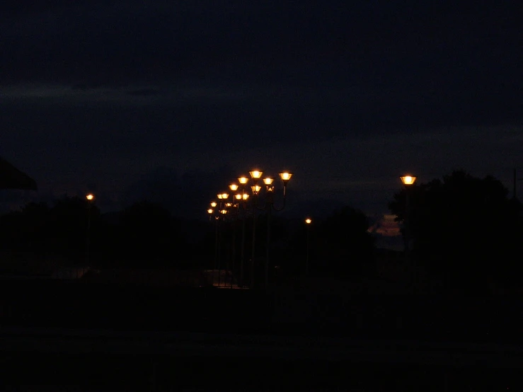a lamp post on a dark night with lights