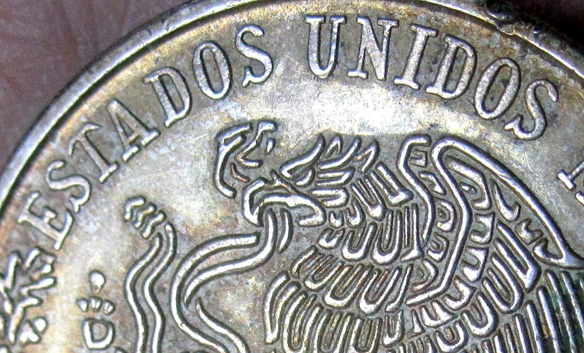 a close up of a coin in silver