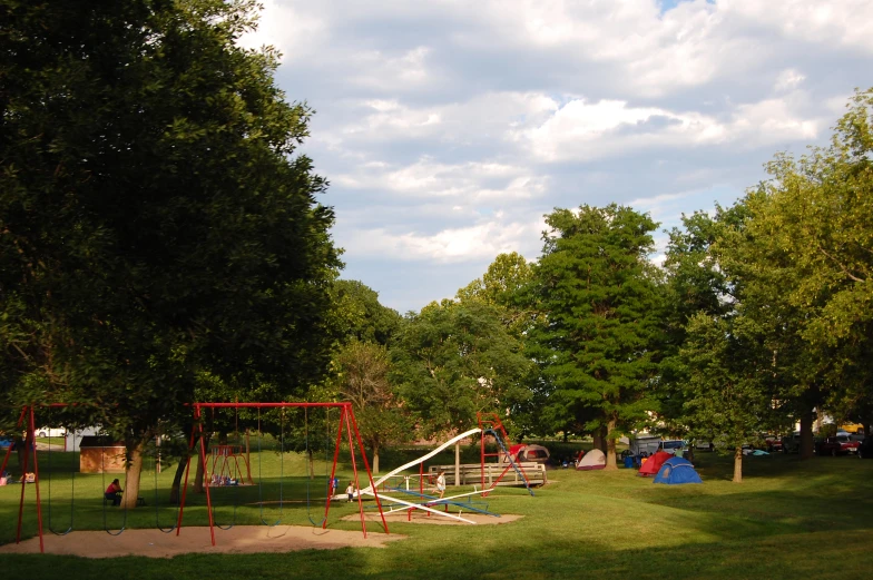 a playground with many swings and swings in the park