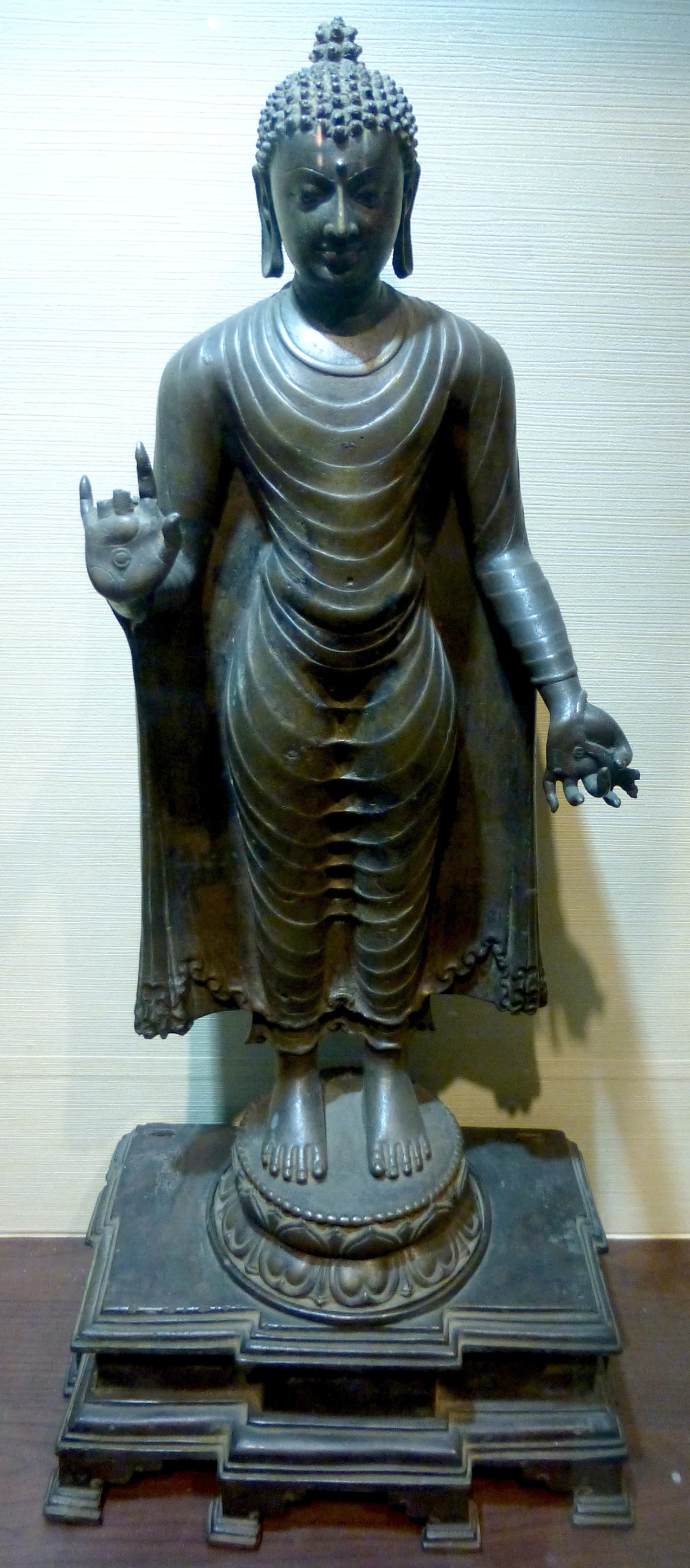 bronze statue of buddha giving the finger, possibly a finger sign