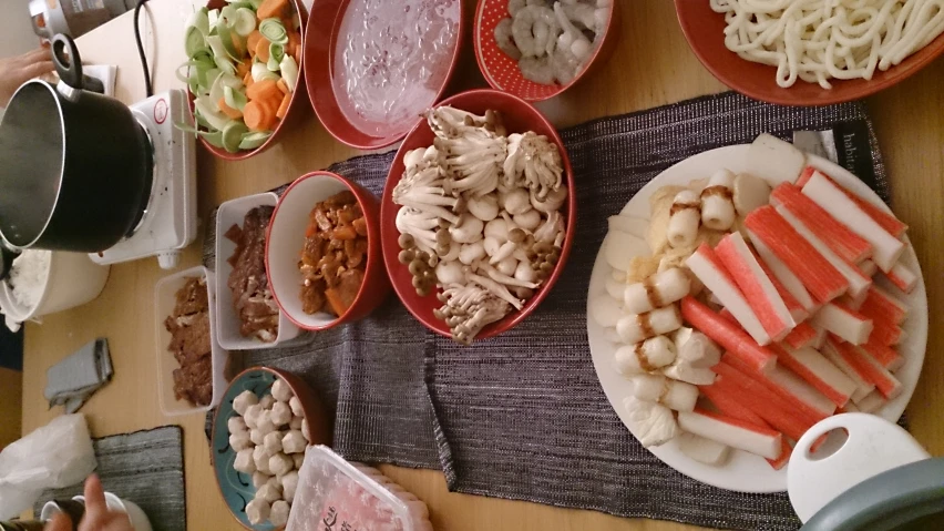a bunch of bowls are filled with food on the table
