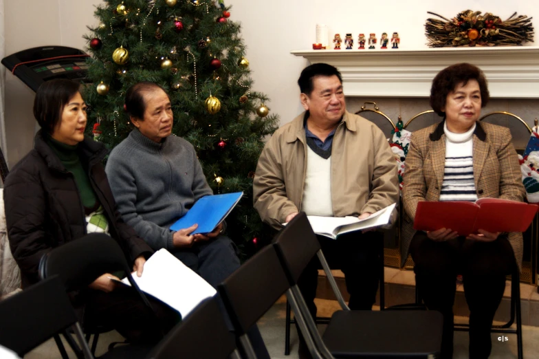 group of people sitting together and talking in a room