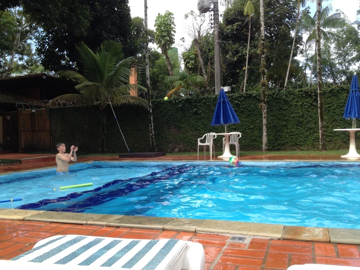 a person jumping into an outdoor pool