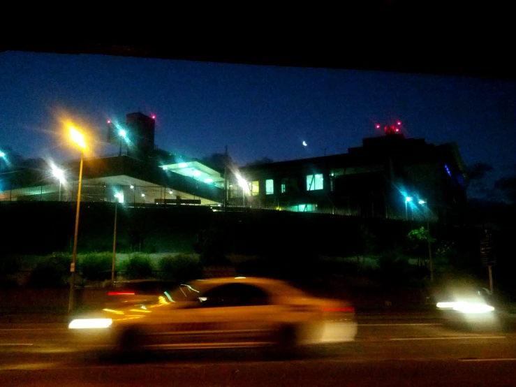 a car passing on the road with blurred headlights