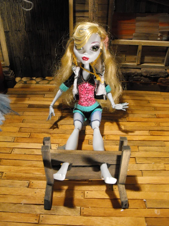 the doll is on the bench on the floor