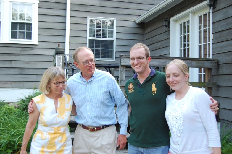 a couple of people are standing in front of a house