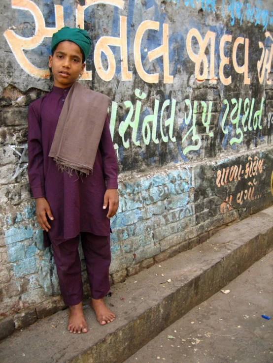 a  in a purple outfit standing on a street