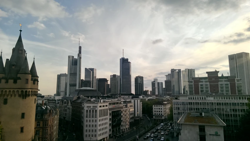 the view of city skyline is from a rooftop