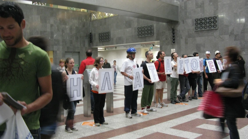 many people holding signs with the words go