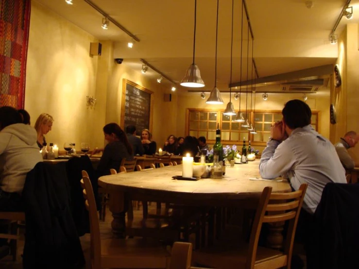 a person sitting at a table with a candle