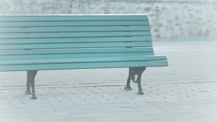 an empty bench sitting on the side of a street