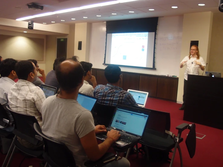 a man giving a presentation in front of a room