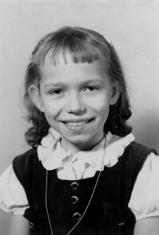 an old po of a little girl smiling at the camera