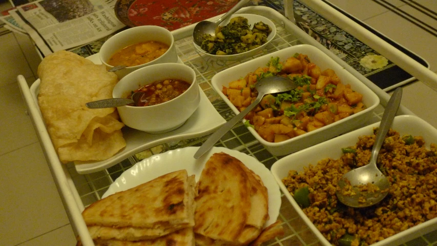 a white serving tray with a variety of food in it