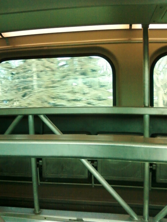 an interior view of a train with green painted rails