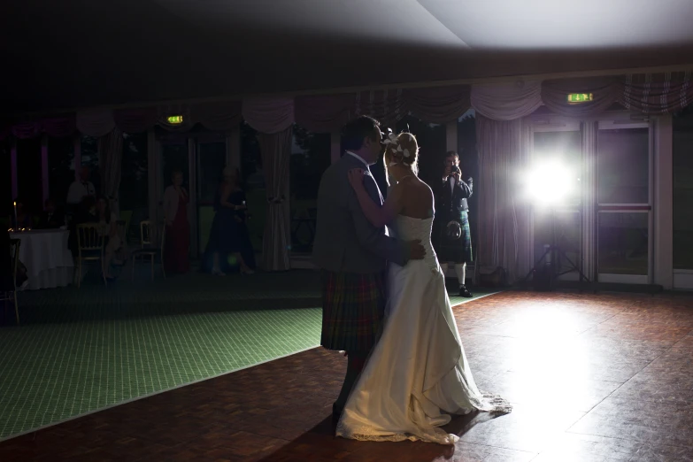 the couple are standing in the dance floor