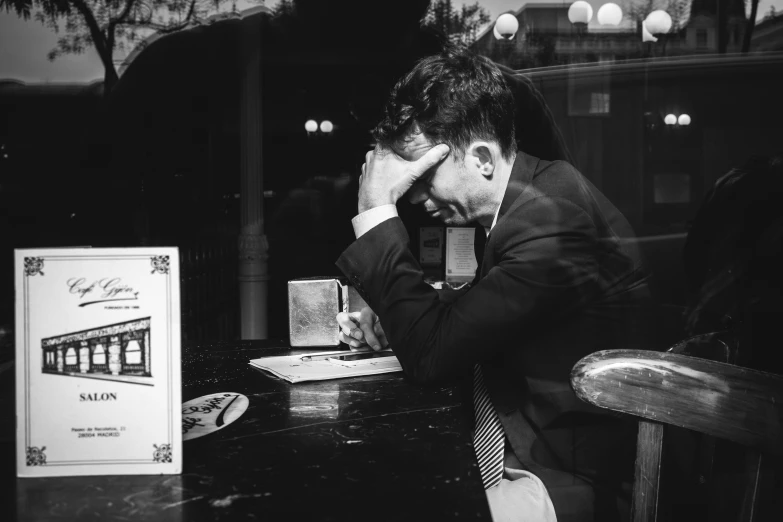 a man in suit is sitting at a table